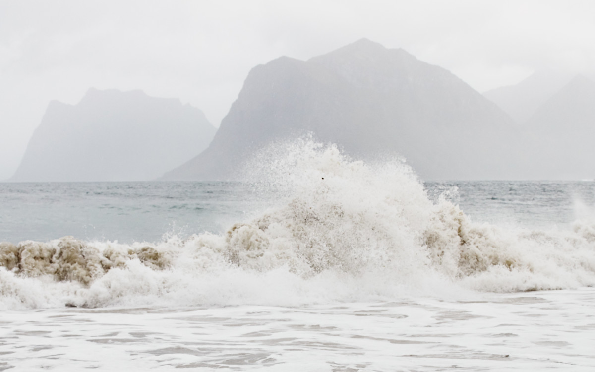 Cut of by the tide Tide, mountains in the background, photography